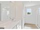 Bright bathroom featuring a white vanity, shower, and wood-look flooring at 1020 Sutherland Lane # 41, Lawrenceville, GA 30043