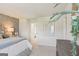 Stylish bedroom with a textured accent wall, neutral carpet, and natural lighting at 1020 Sutherland Lane # 41, Lawrenceville, GA 30043