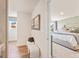 Hallway leading to a bedroom showcases neutral decor, natural light, and hardwood floors at 1020 Sutherland Lane # 41, Lawrenceville, GA 30043