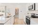 Modern kitchen features stainless steel appliances, granite countertops, white cabinets, and a walk-in pantry at 1020 Sutherland Lane # 41, Lawrenceville, GA 30043