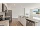 A bright open-concept kitchen with an island featuring stainless steel appliances and granite countertops at 1020 Sutherland Lane # 41, Lawrenceville, GA 30043