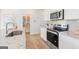 Modern kitchen features stainless steel appliances, white cabinets, granite countertops, and a walk in pantry at 1020 Sutherland Lane # 41, Lawrenceville, GA 30043