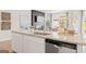 Kitchen island boasts granite countertops, stainless steel dishwasher, and a view of the outdoor scenery at 1020 Sutherland Lane # 41, Lawrenceville, GA 30043