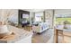 Open concept living space includes modern furnishings, fireplace, a dining area, and views of the outdoors at 1020 Sutherland Lane # 41, Lawrenceville, GA 30043