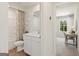 Well-lit bathroom featuring a shower-tub combo, a white vanity and views into the bedroom space at 1020 Sutherland Lane # 43, Lawrenceville, GA 30043