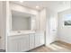 Bathroom featuring a double vanity, a large mirror, and wood-look flooring at 1020 Sutherland Lane # 43, Lawrenceville, GA 30043