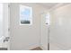 A clean bathroom with a glass-enclosed shower and a window, featuring light walls at 1020 Sutherland Lane # 43, Lawrenceville, GA 30043