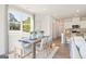 Well-lit dining area with a wooden table set, complemented by contemporary chairs and an open view to the kitchen at 1020 Sutherland Lane # 43, Lawrenceville, GA 30043