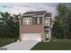 Charming two-story home with a brick and gray exterior and attached two car garage at 1020 Sutherland Lane # 43, Lawrenceville, GA 30043