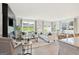 Open-concept living room featuring a fireplace, large windows, and comfortable seating arrangements at 1020 Sutherland Lane # 43, Lawrenceville, GA 30043