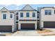 Modern townhome exterior features a gray garage door and a white brick facade at 1028 Sutherland Lane # 45, Lawrenceville, GA 30043
