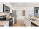 Modern kitchen featuring granite countertops, white cabinets, stainless steel appliances and open to living space at 1028 Sutherland Lane # 45, Lawrenceville, GA 30043