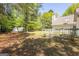 Expansive backyard with mature trees, white vinyl privacy fencing and storage shed at 12843 Simmons Rd, Hampton, GA 30228