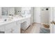 Bathroom with double vanity, framed mirrors, and tiled floor at 12843 Simmons Rd, Hampton, GA 30228