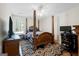 Bedroom with four-poster bed, carpet, and natural light at 12843 Simmons Rd, Hampton, GA 30228