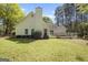 Back of house with vinyl siding, well-maintained lawn, and classic architectural design at 12843 Simmons Rd, Hampton, GA 30228