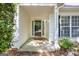 Inviting front porch featuring a glass front door and shade at 12843 Simmons Rd, Hampton, GA 30228
