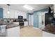 Kitchen with white cabinetry, stainless steel appliances, and tiled floors at 12843 Simmons Rd, Hampton, GA 30228