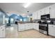 Well-lit kitchen with white cabinets and stainless steel appliances at 12843 Simmons Rd, Hampton, GA 30228