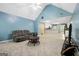 Open-concept living room with vaulted ceiling adjacent to kitchen area at 12843 Simmons Rd, Hampton, GA 30228