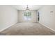 Spacious living room with neutral carpet, chandelier, and natural light at 12843 Simmons Rd, Hampton, GA 30228
