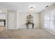 Large room featuring neutral carpet, natural light, and a view of the kitchen at 12843 Simmons Rd, Hampton, GA 30228