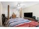 Spacious main bedroom featuring wood post bed frame, neutral walls, and ceiling fan for added comfort at 12843 Simmons Rd, Hampton, GA 30228
