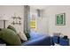 Charming bedroom featuring a blue bedspread, window views, and sports decor at 576 Silver Moon Dr, Loganville, GA 30052
