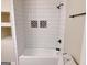 Bathroom with modern tile, tub with shower, and new fixtures at 674 Jett Nw St, Atlanta, GA 30318