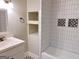 Bathroom featuring white vanity, modern fixtures, and subway tile shower at 674 Jett Nw St, Atlanta, GA 30318