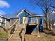 Back exterior view featuring a deck and fenced yard with blue siding at 674 Jett Nw St, Atlanta, GA 30318