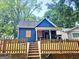 Charming blue home with inviting front porch and wooden fence, full of potential at 674 Jett Nw St, Atlanta, GA 30318