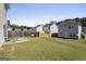 Spacious backyard showing the lawn, fence line, and rear exteriors of the adjacent homes at 7756 Newbury Dr, Jonesboro, GA 30236