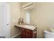 Bright bathroom features a single sink vanity with dark wood cabinets and an overhanging mirror at 7756 Newbury Dr, Jonesboro, GA 30236
