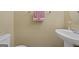 Cozy bathroom features a pedestal sink with towel and decorative objects at 7756 Newbury Dr, Jonesboro, GA 30236