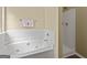 Bright bathroom features a soaking tub with shower and a separate enclosed shower stall at 7756 Newbury Dr, Jonesboro, GA 30236
