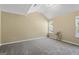 Spacious carpeted bedroom features lots of natural light and neutral paint at 7756 Newbury Dr, Jonesboro, GA 30236