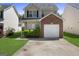 Charming two-story home with attached brick garage and well-maintained landscaping, curb appeal at 7756 Newbury Dr, Jonesboro, GA 30236
