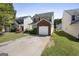 Charming two-story home with an attached brick garage and a concrete driveway leading to the front at 7756 Newbury Dr, Jonesboro, GA 30236