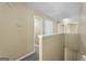 Hallway featuring a carpeted floor, white trim, and access to multiple rooms at 7756 Newbury Dr, Jonesboro, GA 30236