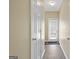 Hallway with luxury vinyl plank flooring leads to an exterior door with mini-blinds at 7756 Newbury Dr, Jonesboro, GA 30236