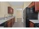 Efficient kitchen featuring wooden cabinetry, stainless appliances, and gray flooring at 7756 Newbury Dr, Jonesboro, GA 30236