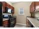 Well-equipped kitchen with gas range, stainless appliances, and dark wood cabinets at 7756 Newbury Dr, Jonesboro, GA 30236
