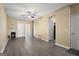Open living room showcasing a fireplace, gray flooring, and a ceiling fan at 7756 Newbury Dr, Jonesboro, GA 30236