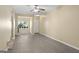 Bright living room featuring gray flooring, a ceiling fan, and a view to the outside at 7756 Newbury Dr, Jonesboro, GA 30236