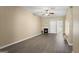 Cozy living room featuring gray flooring, a fireplace, and a ceiling fan at 7756 Newbury Dr, Jonesboro, GA 30236