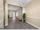 Spacious living room with gray flooring, a chandelier and connection to other rooms at 7756 Newbury Dr, Jonesboro, GA 30236