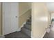 Carpeted staircase with white handrail leads to the upper level of the home at 7756 Newbury Dr, Jonesboro, GA 30236