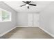 Bedroom featuring light wood floors, neutral walls, a window view, and double door closet at 474 Autumn Dr, Riverdale, GA 30274