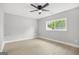 An empty room with neutral walls, wood floors, ceiling fan, and a window providing natural light at 474 Autumn Dr, Riverdale, GA 30274